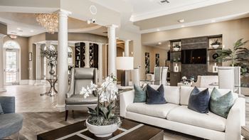 A living room with a white couch and a chandelier